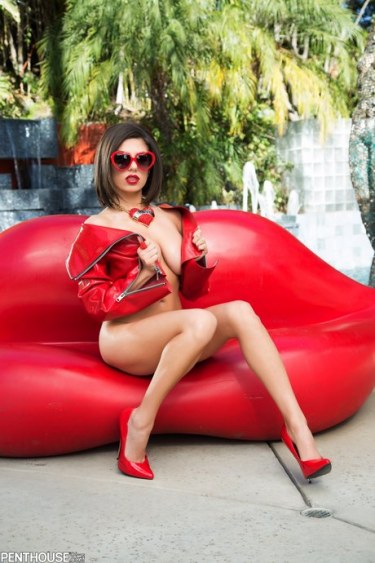 Darcie Dolce In Sunglasses On A Red Sofa 1